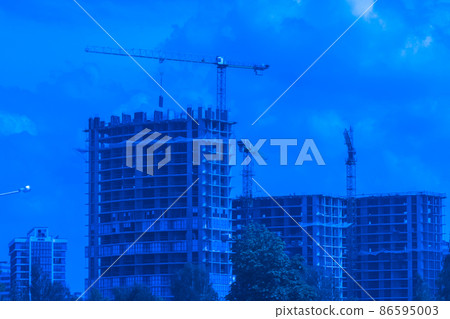 Tower cranes build and development new urban houses architecture industry on blue sky background Tower cranes build and development new urban houses architecture industry on blue sky background 86595003