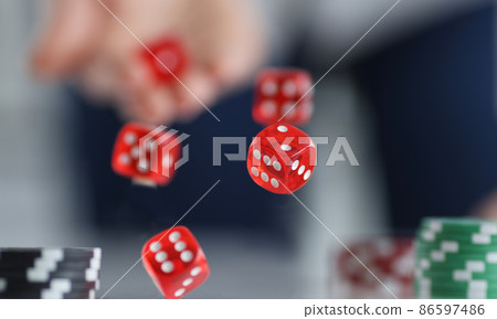 Red dice flying over casino chips closeup Red dice flying over casino chips closeup 86597486