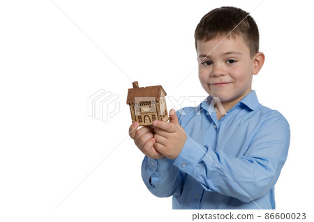 smiling boy with a small house in his hands, concept, on a white background, isolate smiling boy with a small house in his hands, concept, on a white background, isolate 86600023