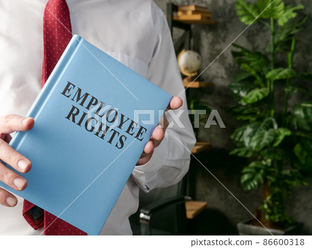 A manager offering a book employee rights. A manager offering a book employee rights. 86600318