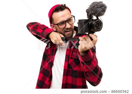 professional videographer fooling around with video camera and microphone aiming equipment like a 86600562