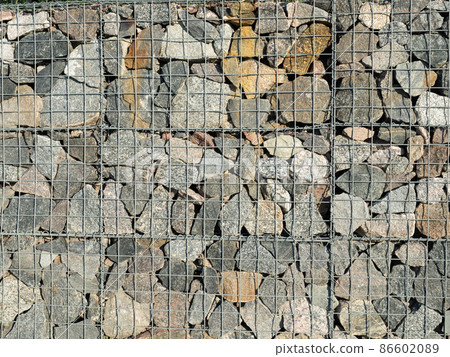 Gabion, a modular containment system made from wire mesh and filled with stones Gabion, a modular containment system made from wire mesh and filled with stones 86602089