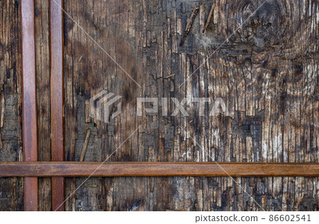 Three narrow wooden slats on a dark wooden background.  86602541