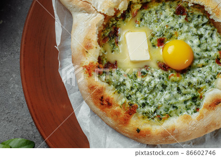 Some khachapuri traditional Georgian homemade cheese and spinach pies on the plate Some khachapuri traditional Georgian homemade cheese and spinach pies on the plate 86602746