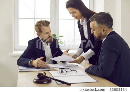 Group of experienced attorneys and lawyers giving consultation to client, helping with difficult lawsuit, explaining legal procedures and discussing agreement terms. Law services and support concept 86603184