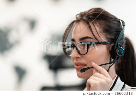 Business and technology concept - helpline female operator with headphones in call centre .Business woman with headsets working in a call center Business and technology concept - helpline female operator with headphones in call centre .Business woman with headsets working in a call center 86603318