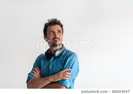 Formal business male portrait. A confident successful casual businessman or manager stands in front of a white background, arms crossed, looking directly at the camera and smiling friendly. High Formal business male portrait. A confident successful casual businessman or manager stands in front of a white background, arms crossed, looking directly at the camera and smiling friendly. High 86603647