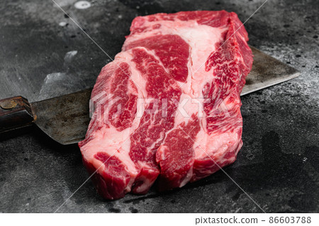 Chuck roll steak, on black dark stone table background, with copy space for text Chuck roll steak, on black dark stone table background, with copy space for text 86603788