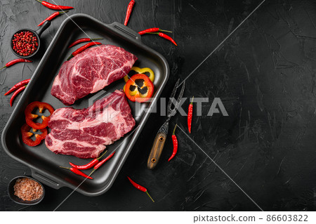 Chuck eye roll beef meat steak, on black dark stone table background, top view flat lay, with copy space for text Chuck eye roll beef meat steak, on black dark stone table background, top view flat lay, with copy space for text 86603822