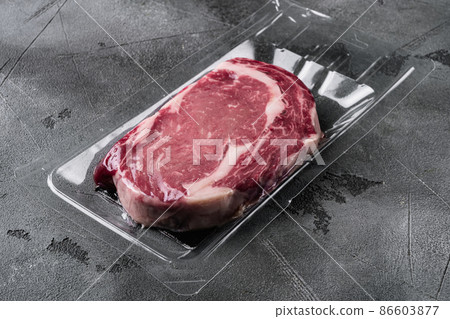 Rib eye steak pack, on gray stone table background, with copy space for text Rib eye steak pack, on gray stone table background, with copy space for text 86603877
