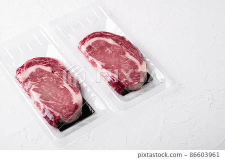 Steak, ribeye, vacuum packing, on white stone table background, with copy space for text Steak, ribeye, vacuum packing, on white stone table background, with copy space for text 86603961