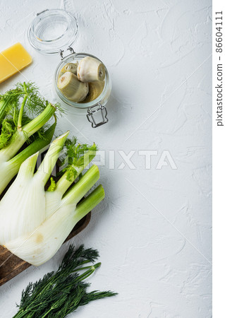 Potato and artichoke al forno ingredients, on white textured background, top view with space for text 86604111