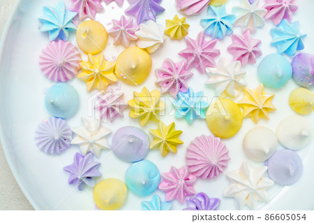 Closeup of delicious colorful meringue cookies on plate. Sweet decor. Confectionery  86605054