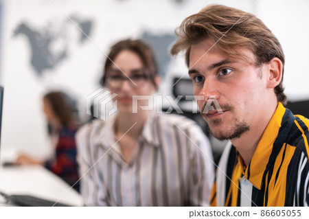 Business couple working together on project using tablet and desktop computer at modern open plan startup office. Selective focus  86605055