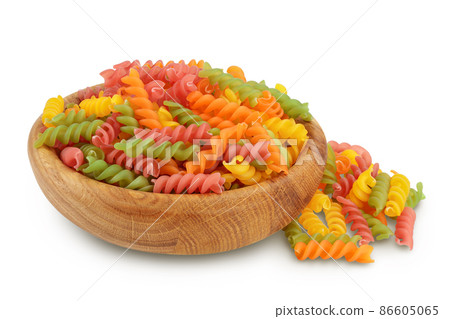 raw Fusilli in wooden bowl colored pasta, isolated on white background with clipping path and full depth of field 86605065