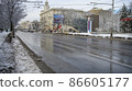 Cars are driving along Bolshaya Sadovaya Street, pedestrians are walking in winter after a snowfall 86605177