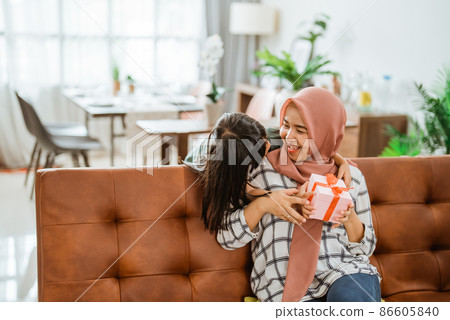 excited mother get new suprise present from her little girl excited mother get new suprise present from her little girl 86605840
