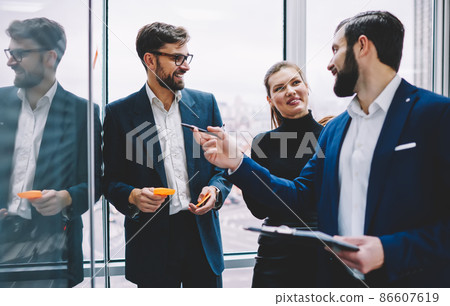 Happy group of office managers talking in office Happy group of office managers talking in office 86607619