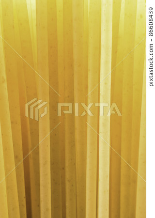 beam of yellow pasta straws on the light beam of yellow pasta straws on the light 86608439