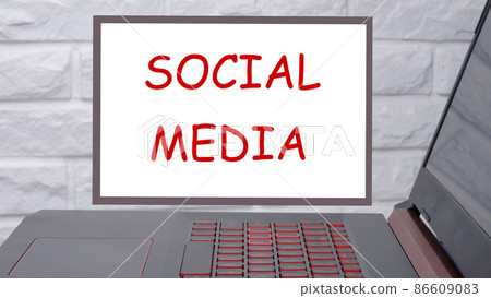 social media phrase written on a magnetic board next to a laptop with a glowing keyboard social media phrase written on a magnetic board next to a laptop with a glowing keyboard 86609083