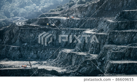 Drilling machines and loader working in diabase quarry Drilling machines and loader working in diabase quarry 86609655