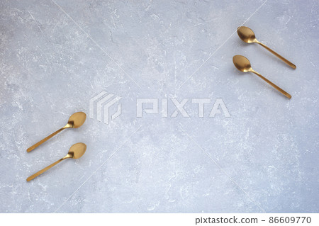 Two pair of spoons opposite each other on grey concrete background, copy space Two pair of spoons opposite each other on grey concrete background, copy space 86609770