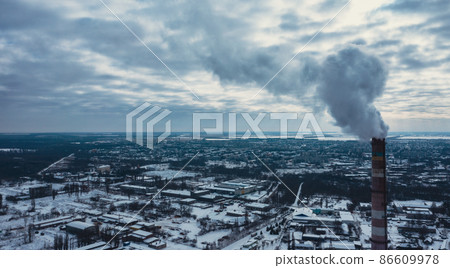 Smog smoke carbon and pollution emissions from industry smokestacks.  Pollution of the atmosphere by an industrial enterprise of the TPS station. 86609978