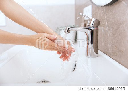 Washing hands under the flowing water tap. Washing hands rubbing with soap for corona virus prevention, hygiene to stop spreading corona virus in or public wash room. Hygiene concept hand detail. Washing hands under the flowing water tap. Washing hands rubbing with soap for corona virus prevention, hygiene to stop spreading corona virus in or public wash room. Hygiene concept hand detail. 86610015