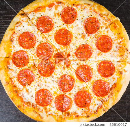 Tasty pepperoni pizza and cooking ingredients tomatoes basil on black concrete background. Top view of hot pepperoni pizza. Banner Tasty pepperoni pizza and cooking ingredients tomatoes basil on black concrete background. Top view of hot pepperoni pizza. Banner 86610017
