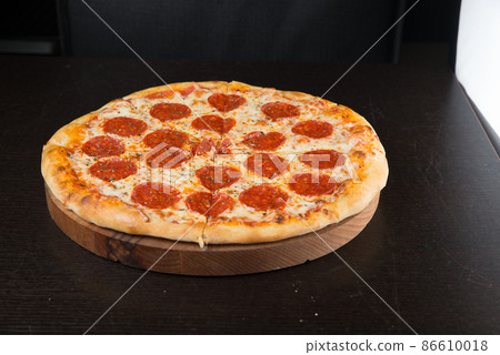 Tasty pepperoni pizza and cooking ingredients tomatoes basil on black concrete background. Top view of hot pepperoni pizza. Banner Tasty pepperoni pizza and cooking ingredients tomatoes basil on black concrete background. Top view of hot pepperoni pizza. Banner 86610018