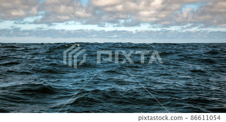 Oceanic and celestial landscape with waves in deep sea waters. 86611054