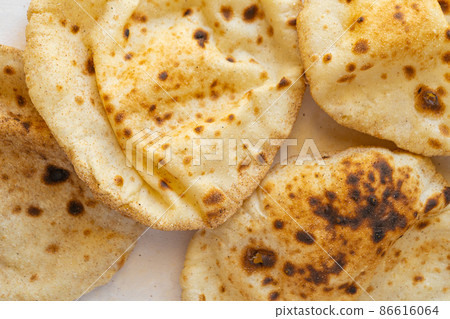 Flat lay of Freashly baked arab flatbreads Flat lay of Freashly baked arab flatbreads 86616064