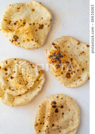 Flat lay of Freashly baked arab flatbreads Flat lay of Freashly baked arab flatbreads 86616065