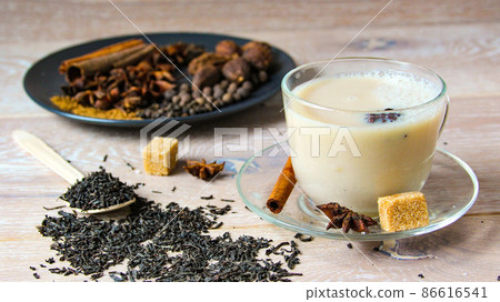 Traditional indian or Asian drink masala tea with spices and sugar in glass cup. 86616541