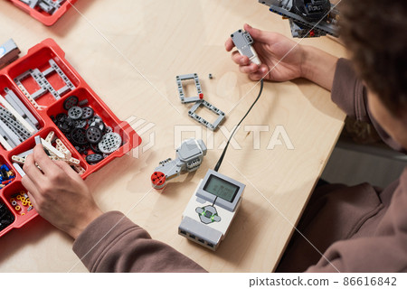 Teenager Building Robot in Class 86616842