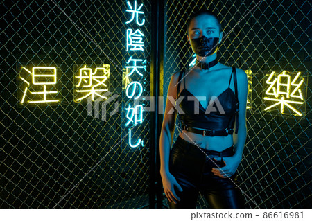 Cyberpunk woman standing at night 86616981
