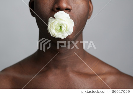 Young man holding white flower Young man holding white flower 86617099
