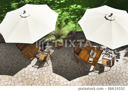 Image of a sunny afternoon open terrace and a table with a laptop / resort work Image of a sunny afternoon open terrace and a table with a laptop / resort work 86619102