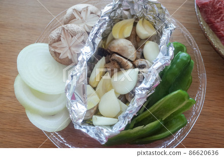 Cut vegetables for grilled meat, garlic and mushrooms in foil 86620636