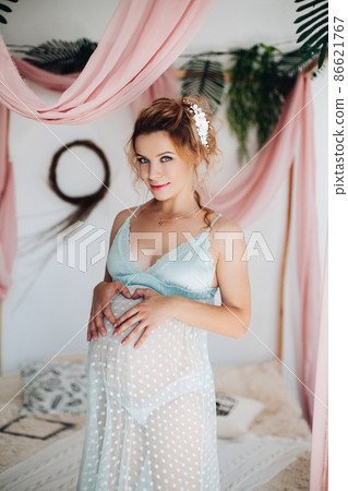Beautiful pregnant woman in nighty dress posing 86621767