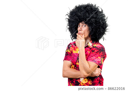 Thoughtful male in Afro wig rubbing chin 86622016