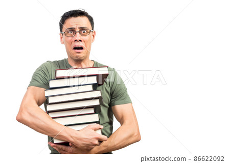 Scared male student with books looking at camera 86622092