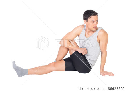 Determined sportsman stretching buttocks muscles in studio 86622231