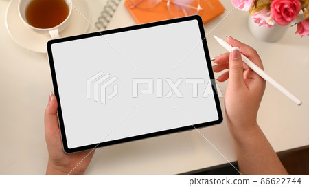 A female designer using stylus pen to sketch her graphic on digital tablet A female designer using stylus pen to sketch her graphic on digital tablet 86622744