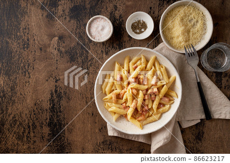 Carbonara pasta. Penne with pancetta, egg, parmesan cheese and cream sauce Carbonara pasta. Penne with pancetta, egg, parmesan cheese and cream sauce 86623217