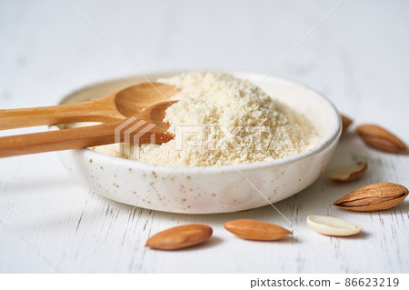 Alternative almond flour. White background, side view, close up Alternative almond flour. White background, side view, close up 86623219