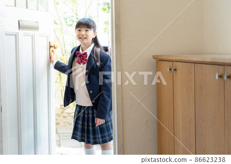 Girl in school uniform going home 86623238