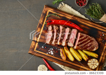 Keto ketogenic diet beef steak, grilled striploin on cutting board. Paleo food recipe with meat 86623399