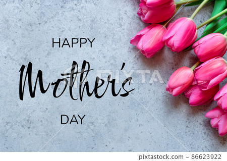 Mother's Day Concept. Fresh tulip flowers on a gray concrete background. Bright spring background. Mother's Day Concept. Fresh tulip flowers on a gray concrete background. Bright spring background. 86623922