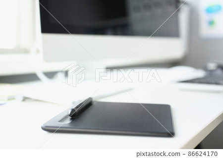 Modern workplace of designer with modern devices on table, tablet stylus and keyboard Modern workplace of designer with modern devices on table, tablet stylus and keyboard 86624170